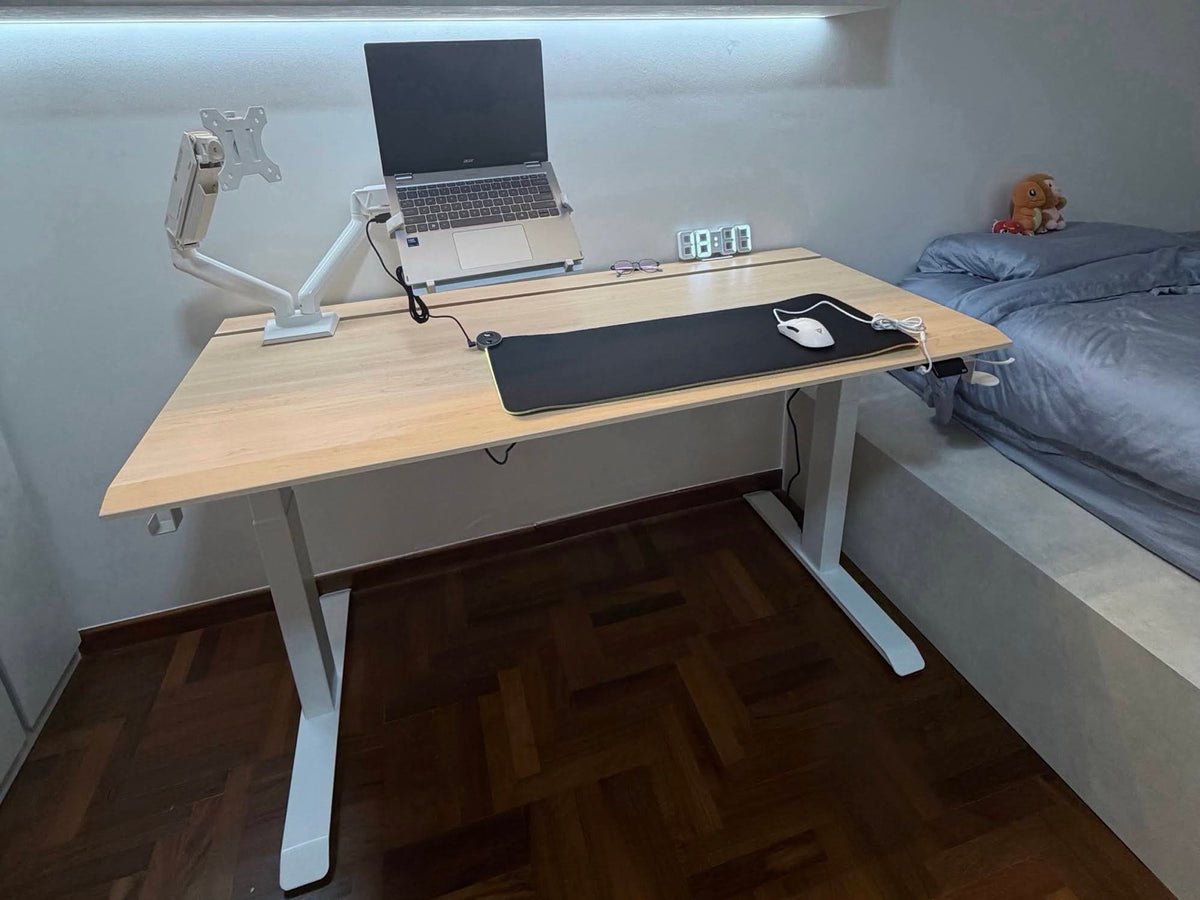 White ULTI standing desk in a bright bedroom workspace