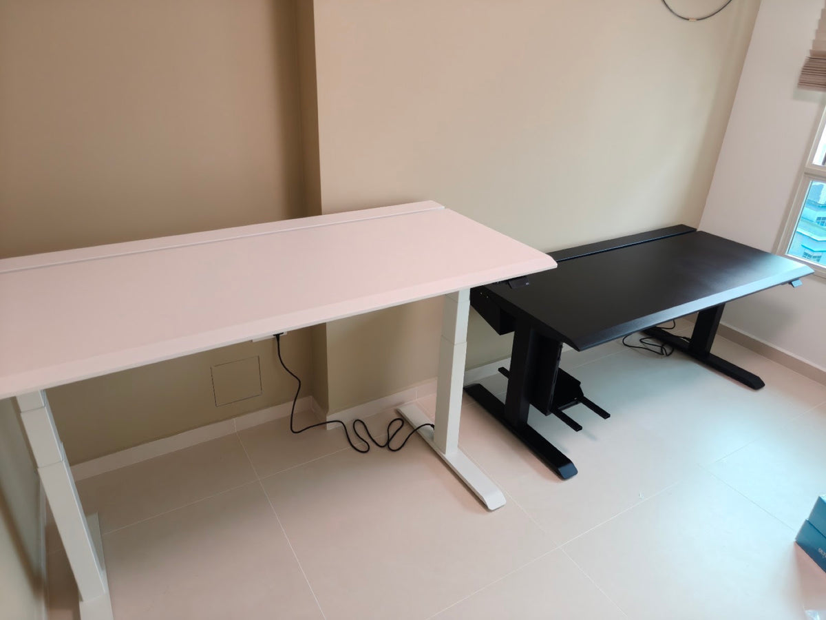 Clean black ULTI standing desk in a bright workspace