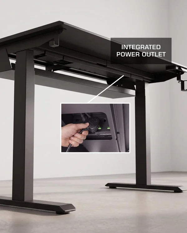 Underside of the Arc Pro V2 desk showing the integrated power outlet